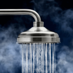 Close up of shower head with water on