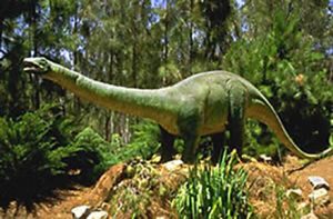Green dinosaur in forest