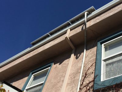 Solar panel piping running along the side of house